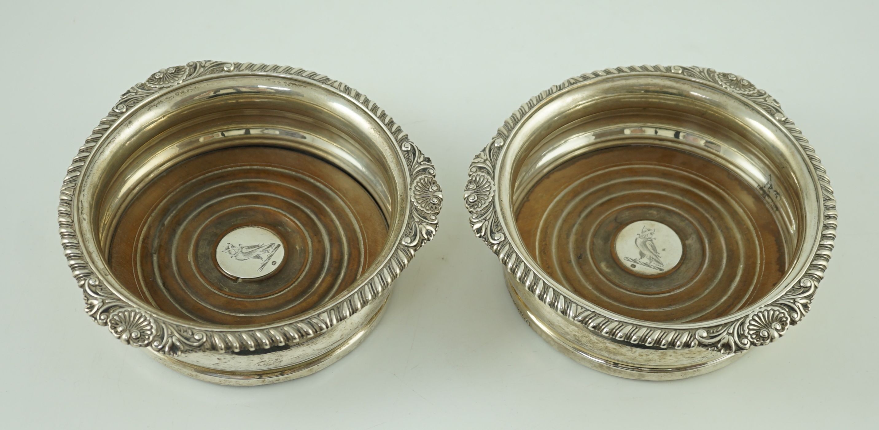 A pair of George IV silver wine coasters by Benjamin Smith III